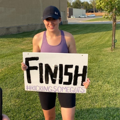 Danielle Austin holding up a "Finish" sign