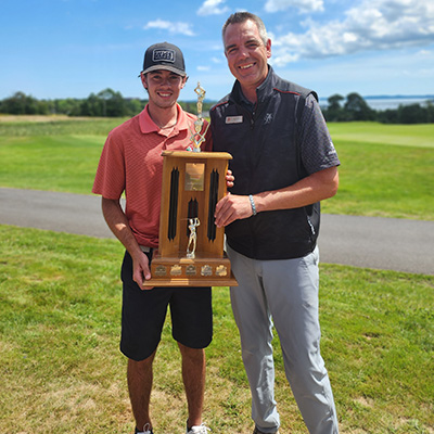 Evan awarding the 2024 Junior Club Champion trophy to Kyle Smith