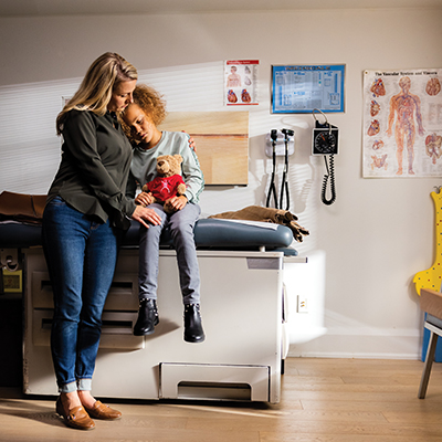 Mom comforting daughter in hospital waiting room