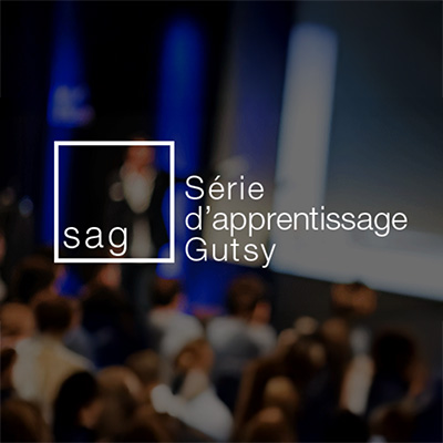 Gutsy Learning Sereies logo on background of a public speaker