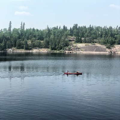 Canoers paddling on a river in Manitoba